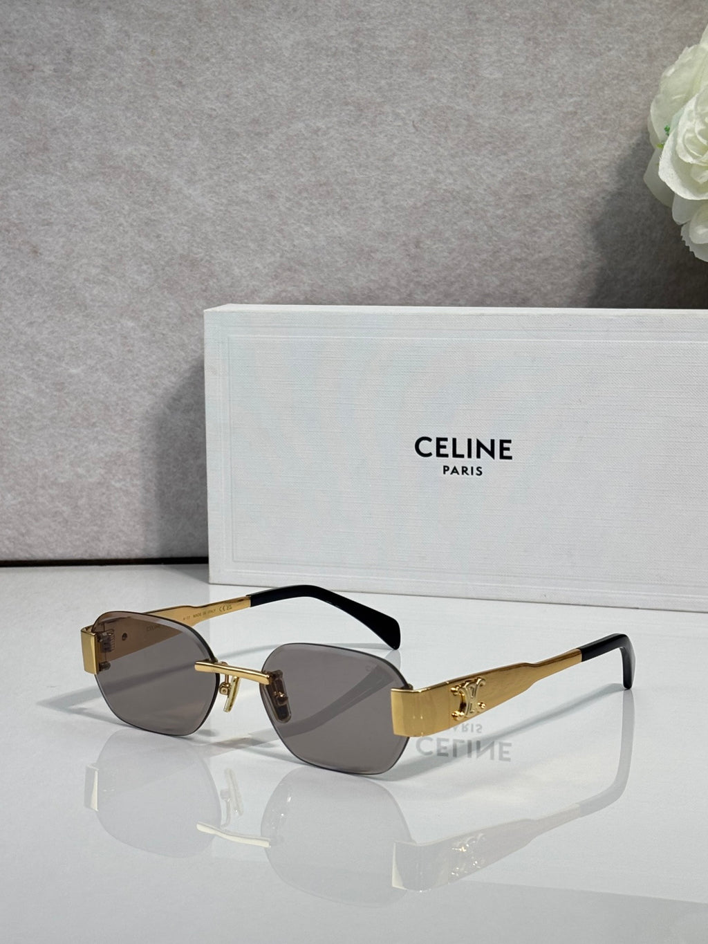 Celine sunglasses with tortoiseshell frames and dark lenses, gold-tone logo arms