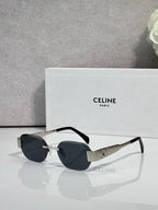 Celine sunglasses with black frames, dark lenses, and gold-tone logo on the temples