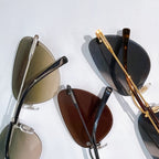 Versace sunglasses pair with olive and dark lenses, silver and gold-tone frames