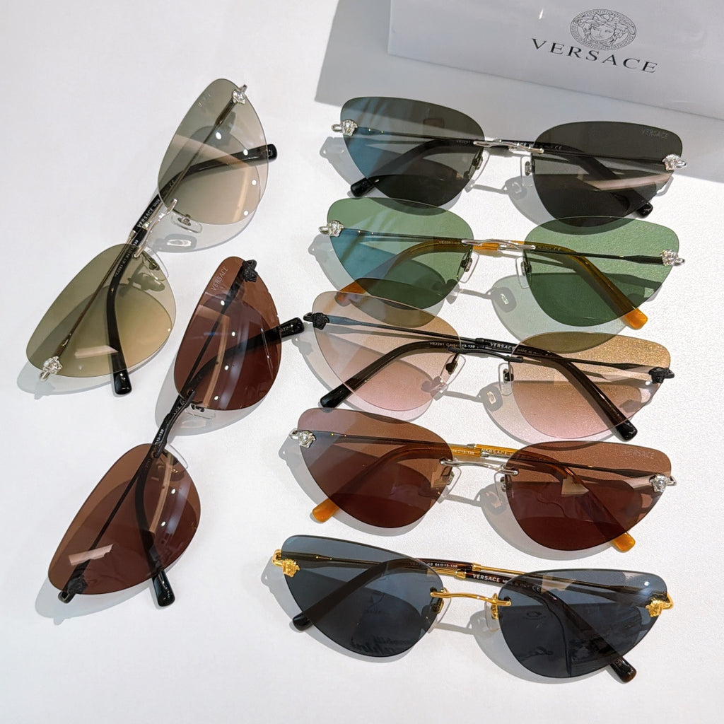 Versace sunglasses assortment with colored lenses and mixed frame tones, laid out together