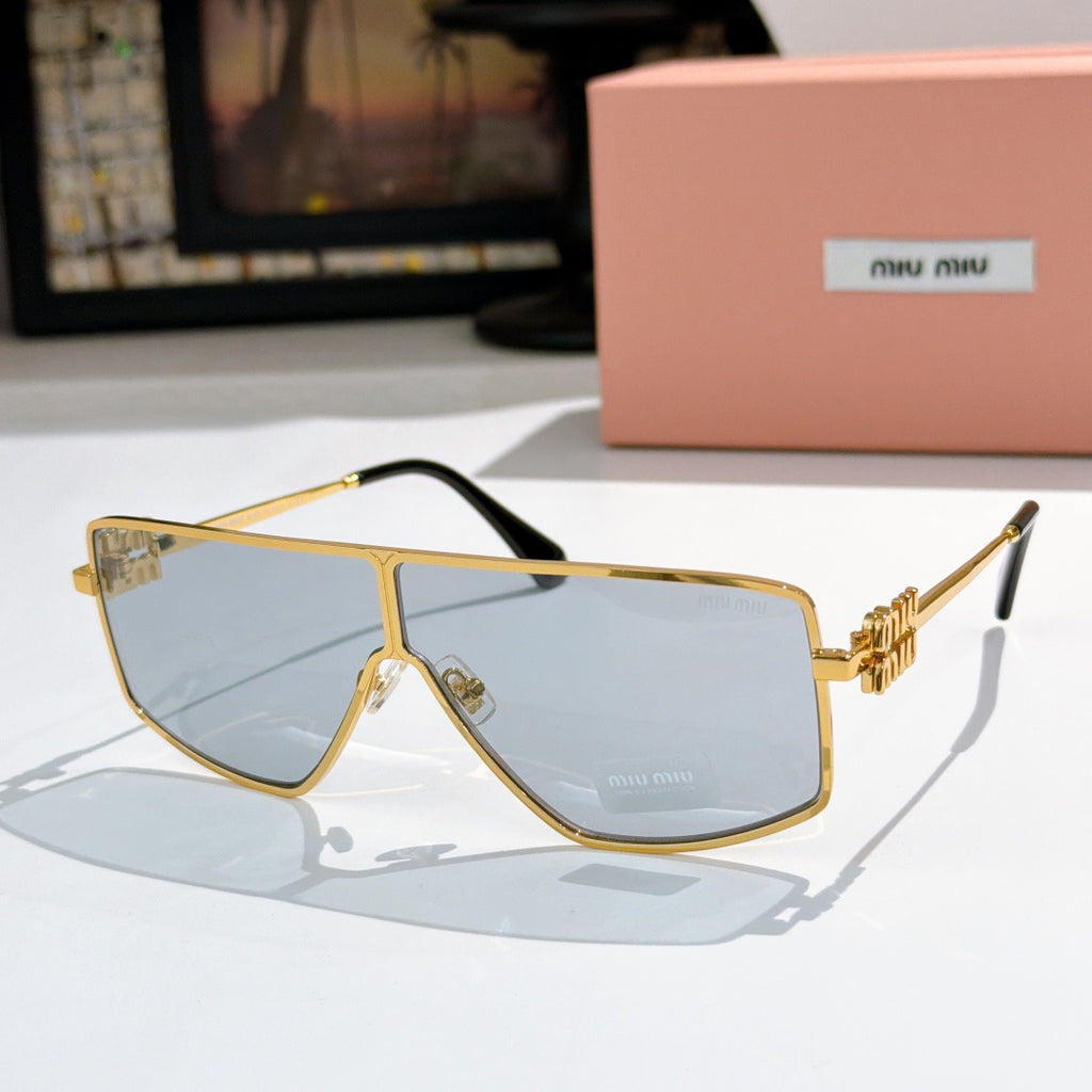 MiuMiu aviator sunglasses with gold frame, light blue lenses, and black temple accents.