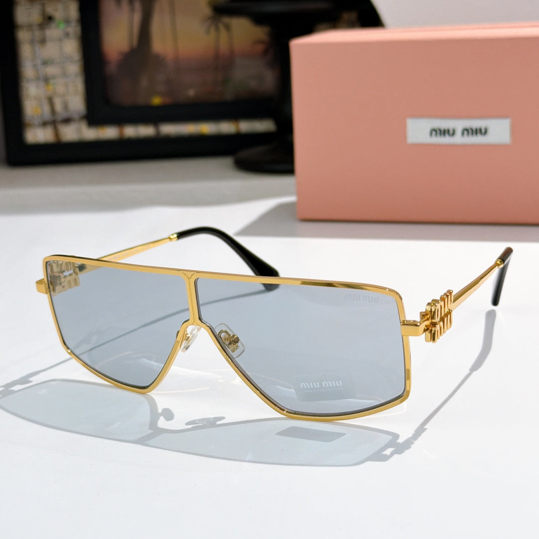 MiuMiu aviator sunglasses with gold frame, light blue lenses, and black temple accents.