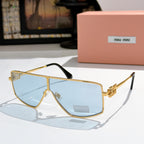 MiuMiu aviator sunglasses with gold frame, light blue lenses, and black temple tips.