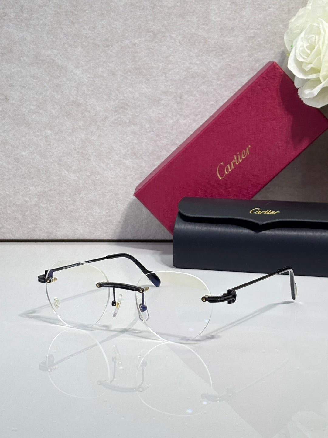 Metal eyeglasses with clear lenses, dark navy rim and gold detailing at hinges