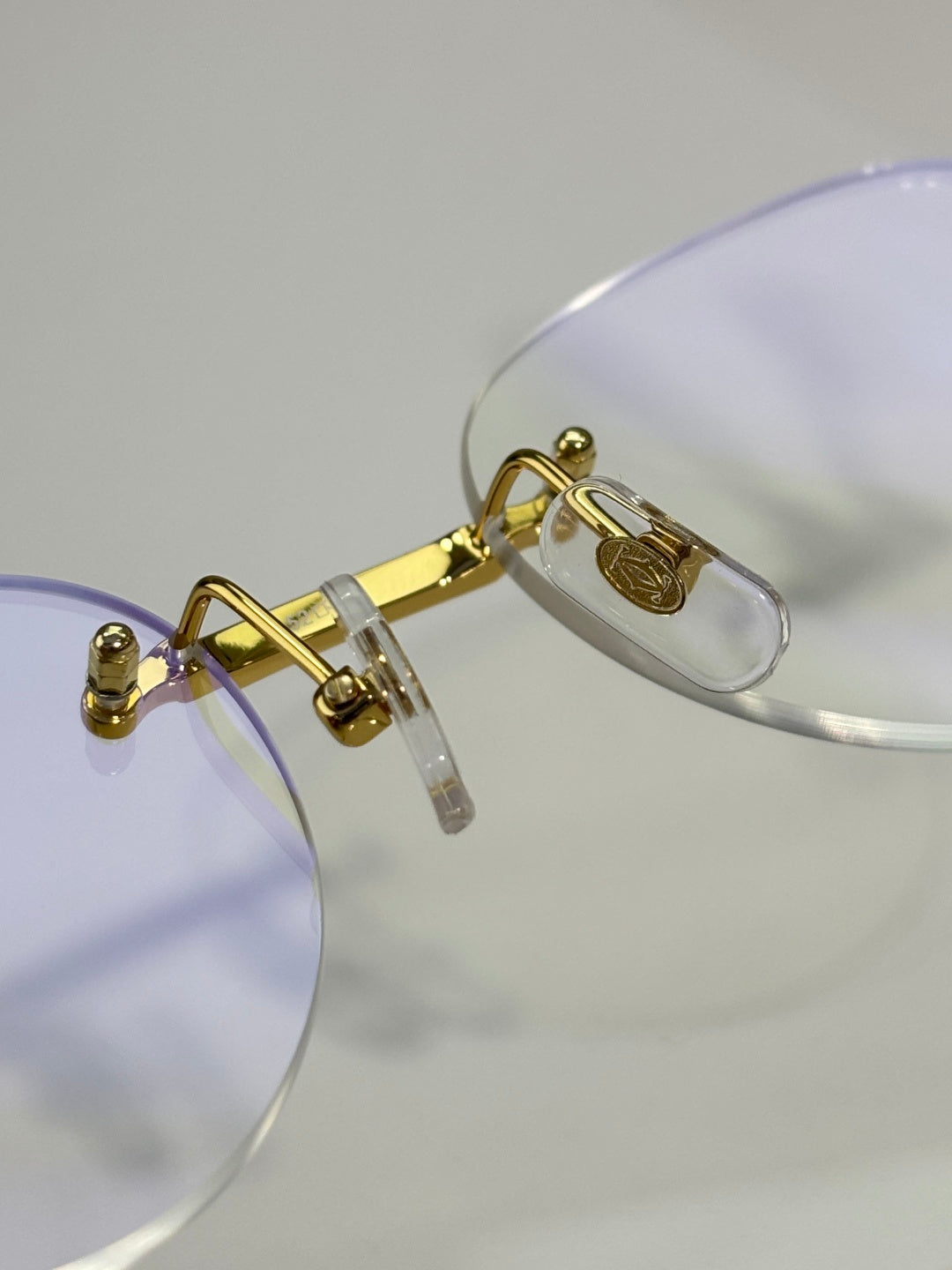 Gold eyeglass frame with clear lenses and lavender temple arms