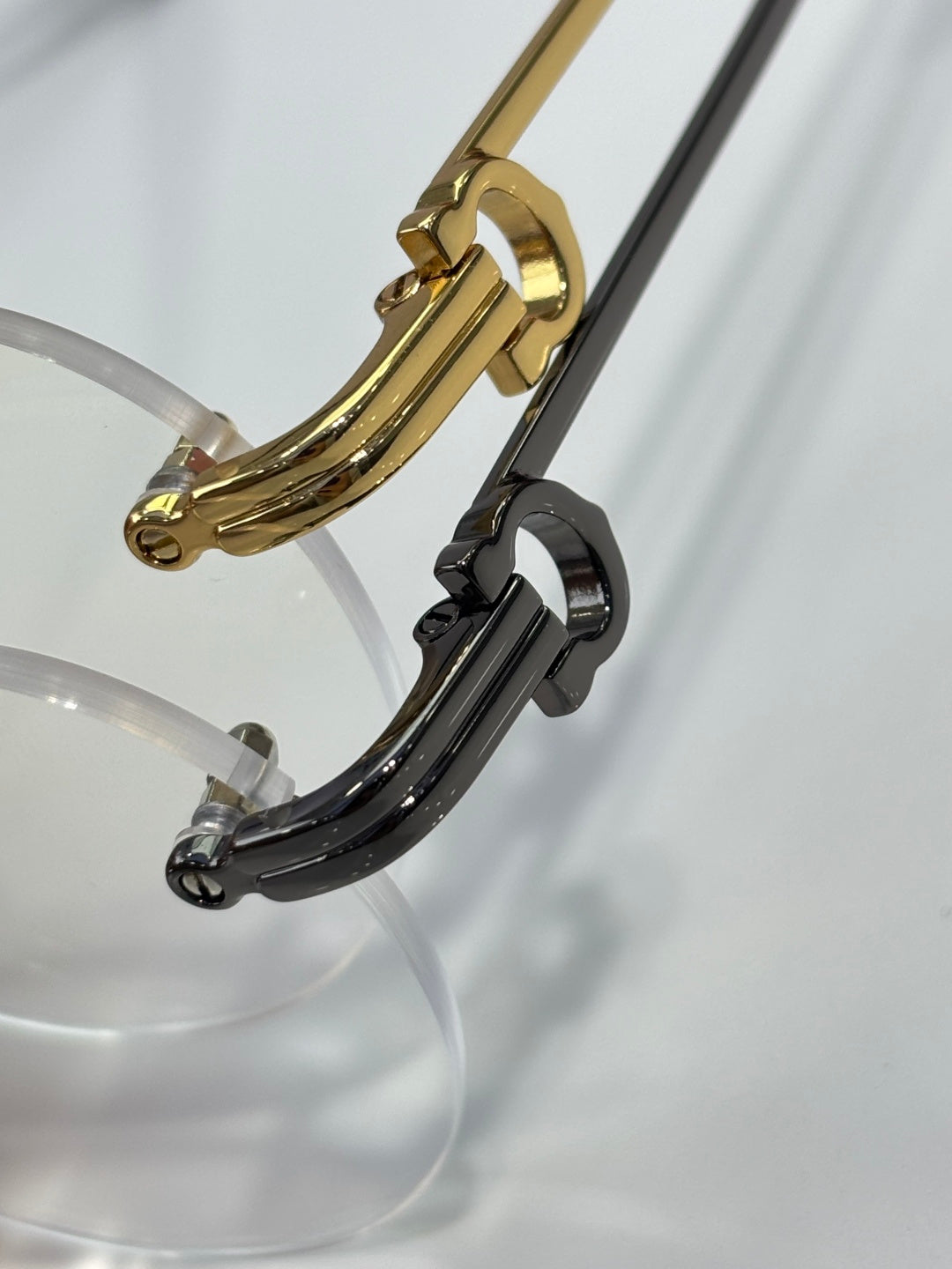 Gold and black eyeglass frame with clear lenses, curved temple detail