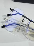 Metal eyeglasses with clear lenses and blue temples with small logo detail