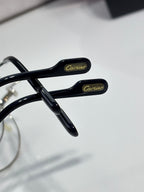 Cartier eyeglasses temple close-up, black arms with Cartier branding in gold