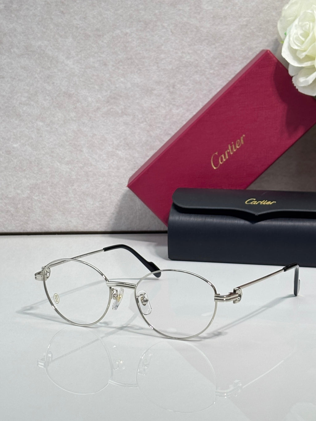Cartier eyeglasses, round clear lenses, thin black frame with gold hinge details