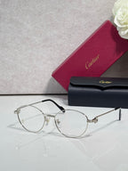 Cartier eyeglasses, round clear lenses, thin black frame with gold hinge details