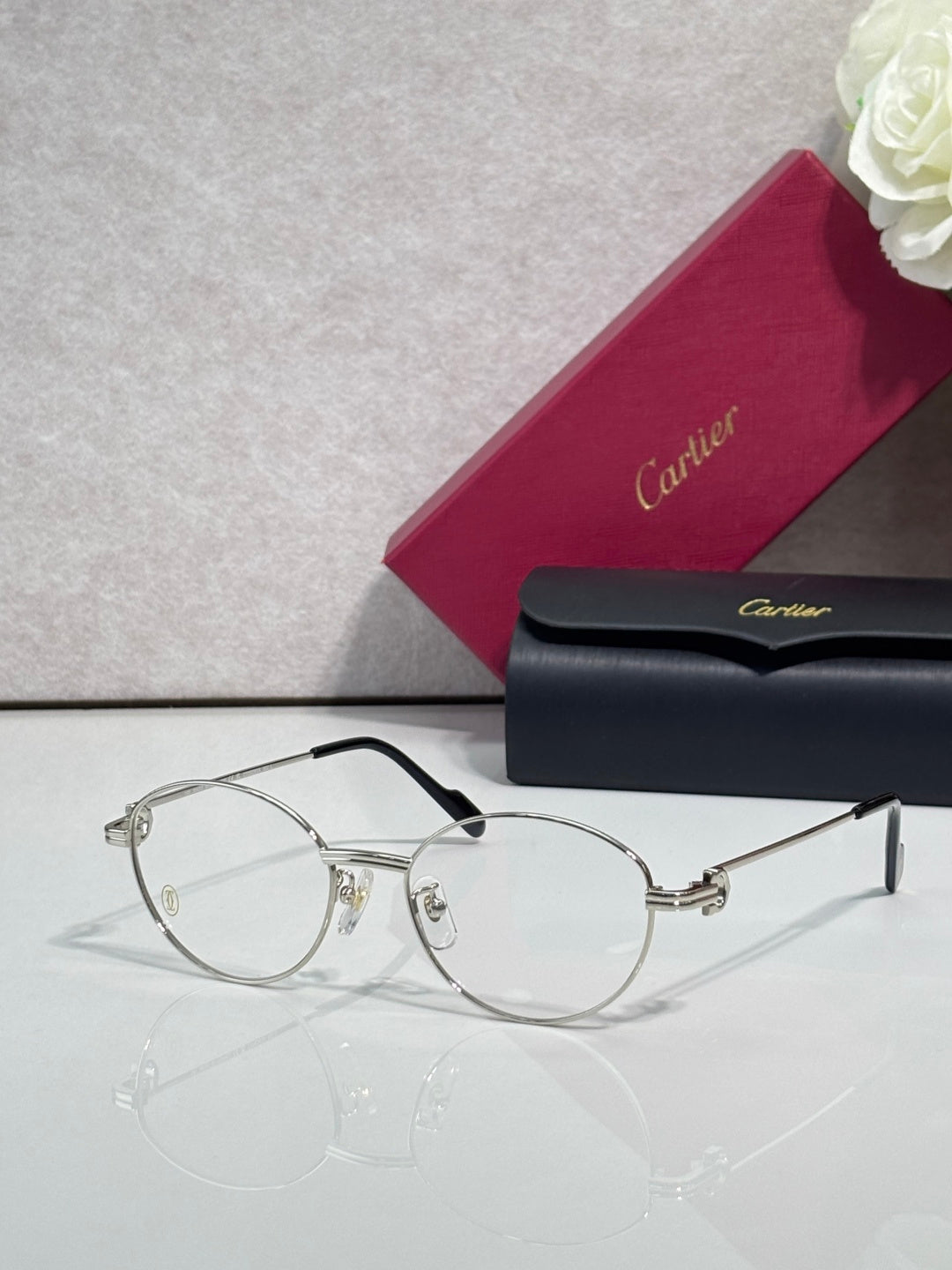 Cartier eyeglasses, round clear lenses, thin black frame with gold hinge details