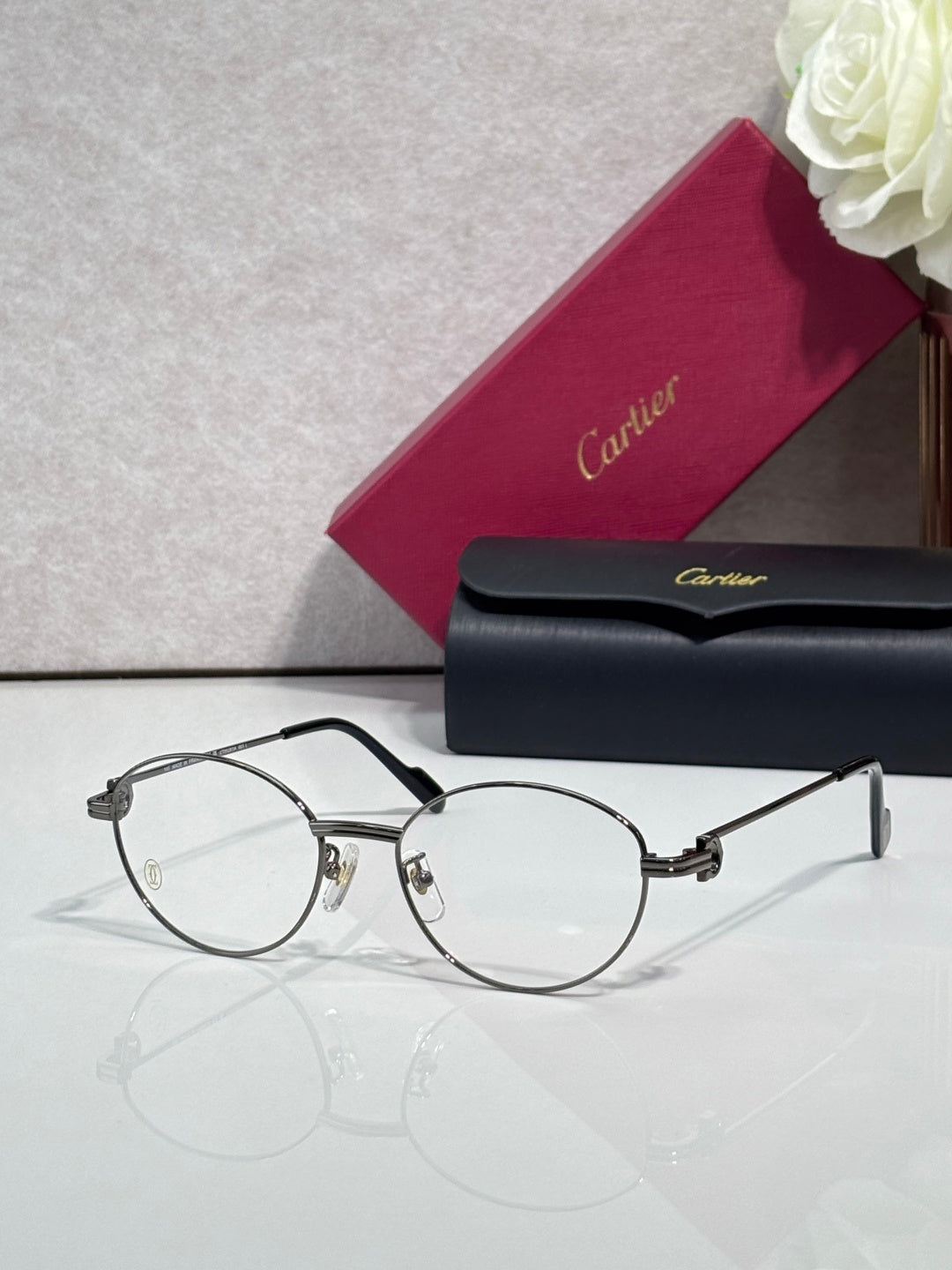 Cartier eyeglasses, round clear lenses, thin black frame with gold accents