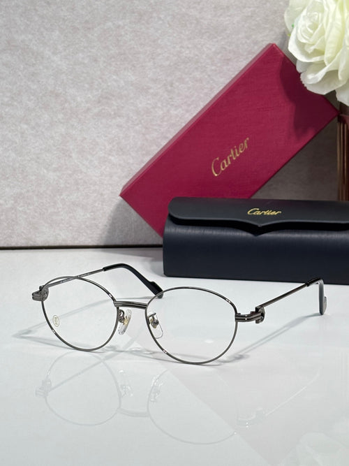 Cartier eyeglasses, round clear lenses, thin black frame with gold accents