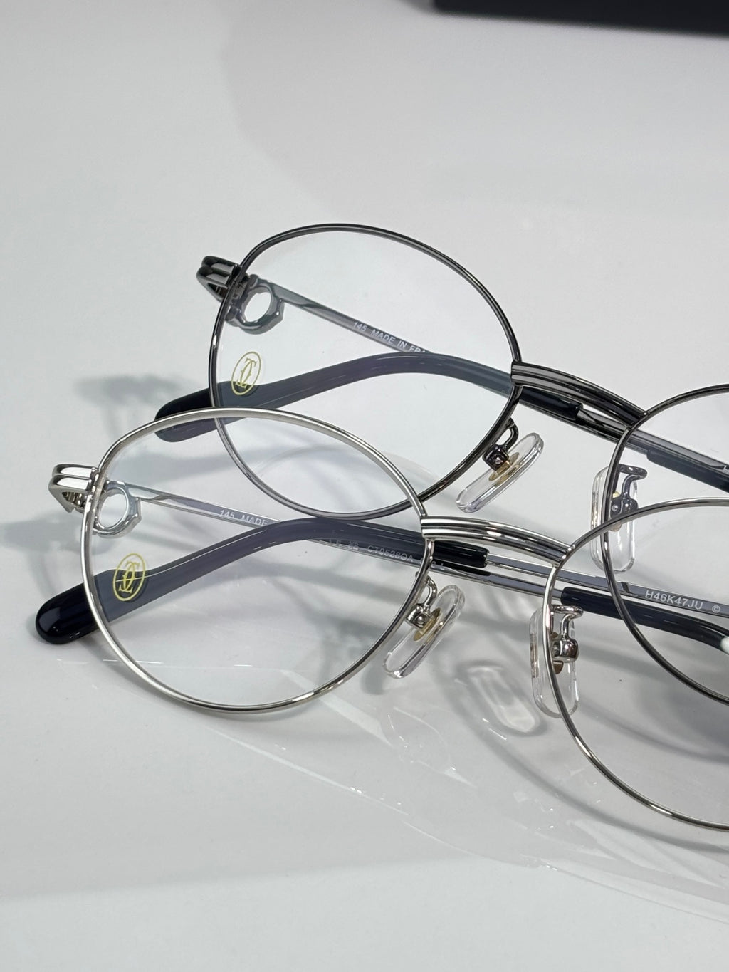 Cartier eyeglasses pair, round clear lenses on silver and black frames
