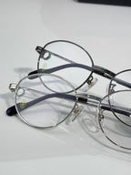 Cartier eyeglasses pair, round clear lenses on silver and black frames