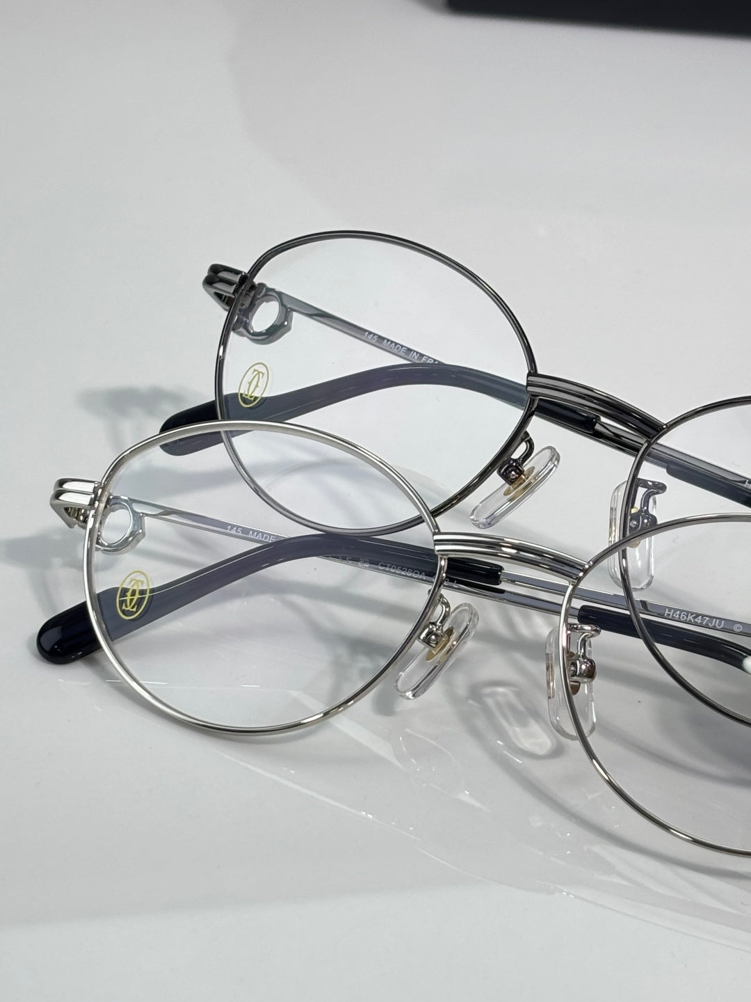 Cartier eyeglasses pair, round clear lenses on silver and black frames