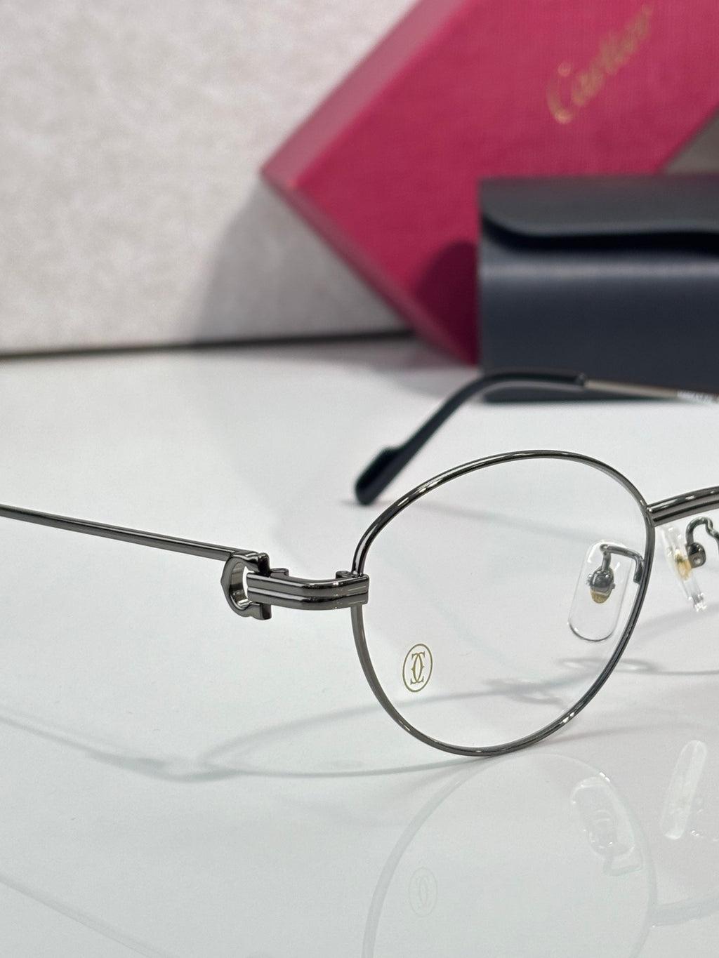 Round metal eyeglasses side view with clear lens and metal hinge details