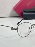 Round metal eyeglasses side view with clear lens and metal hinge details