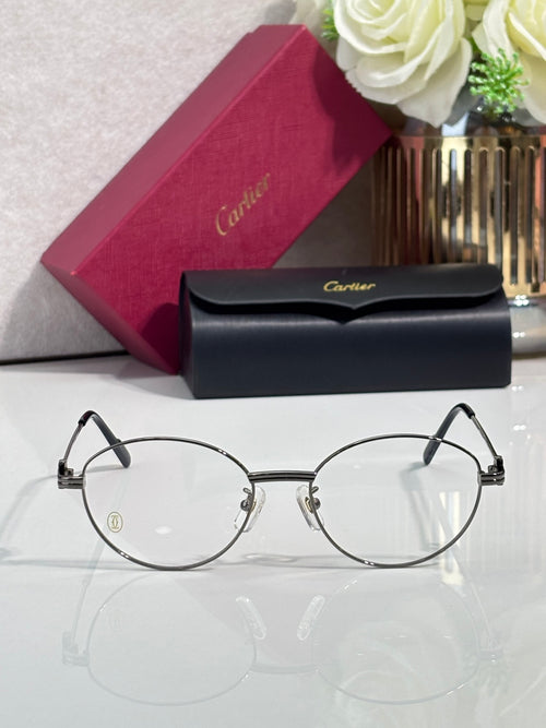 Round metal eyeglasses with clear lenses, black temples, and logo details