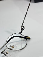 Round metal eyeglasses side view with black temple arm and printed logo strip
