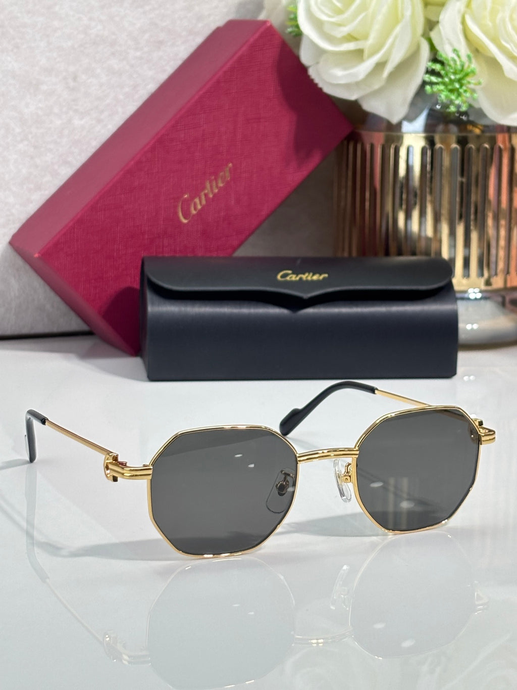 Cartier sunglasses with gold metal frame and dark gray round lenses