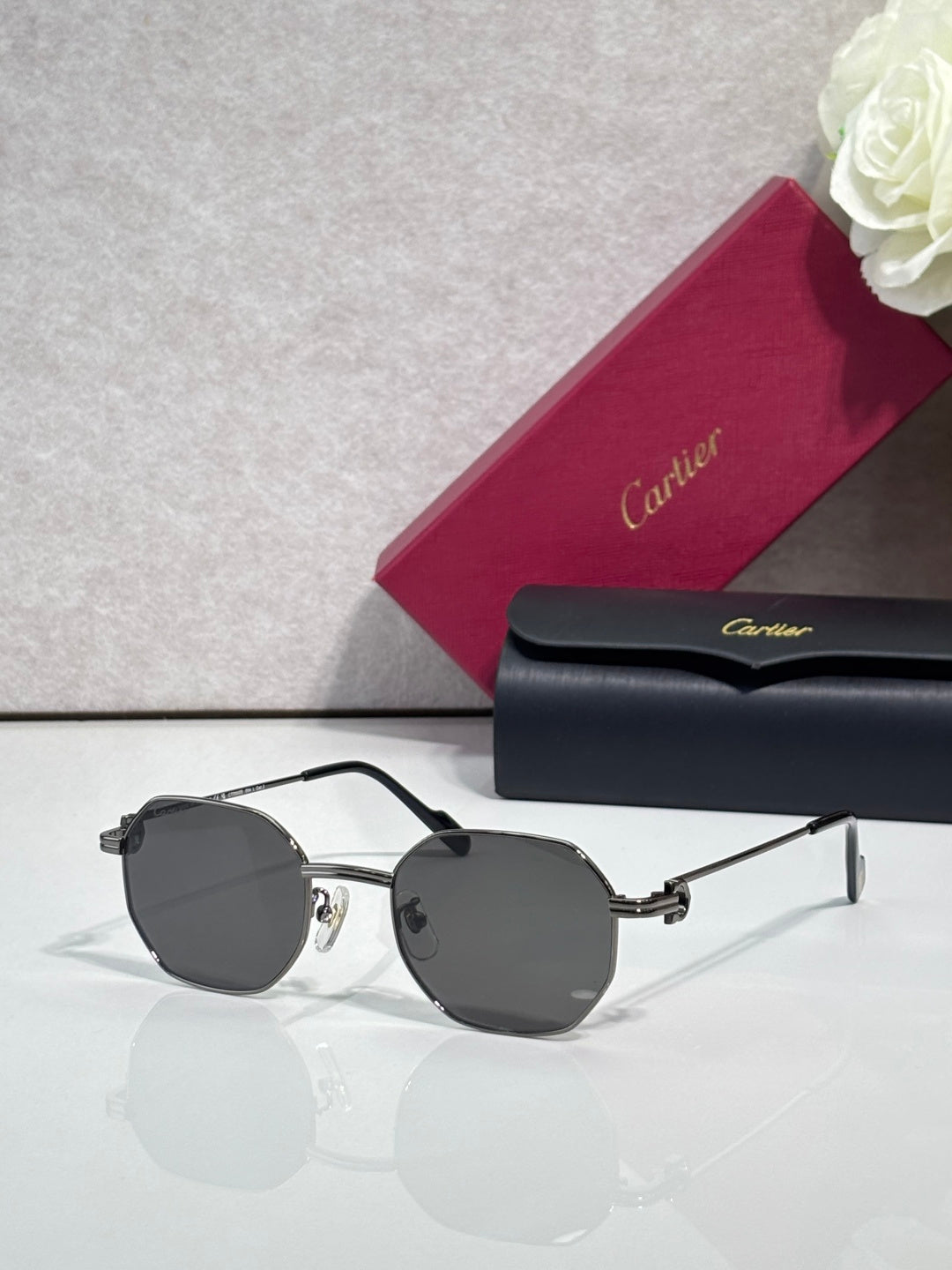 Cartier sunglasses with silver metal frame and dark gray round lenses