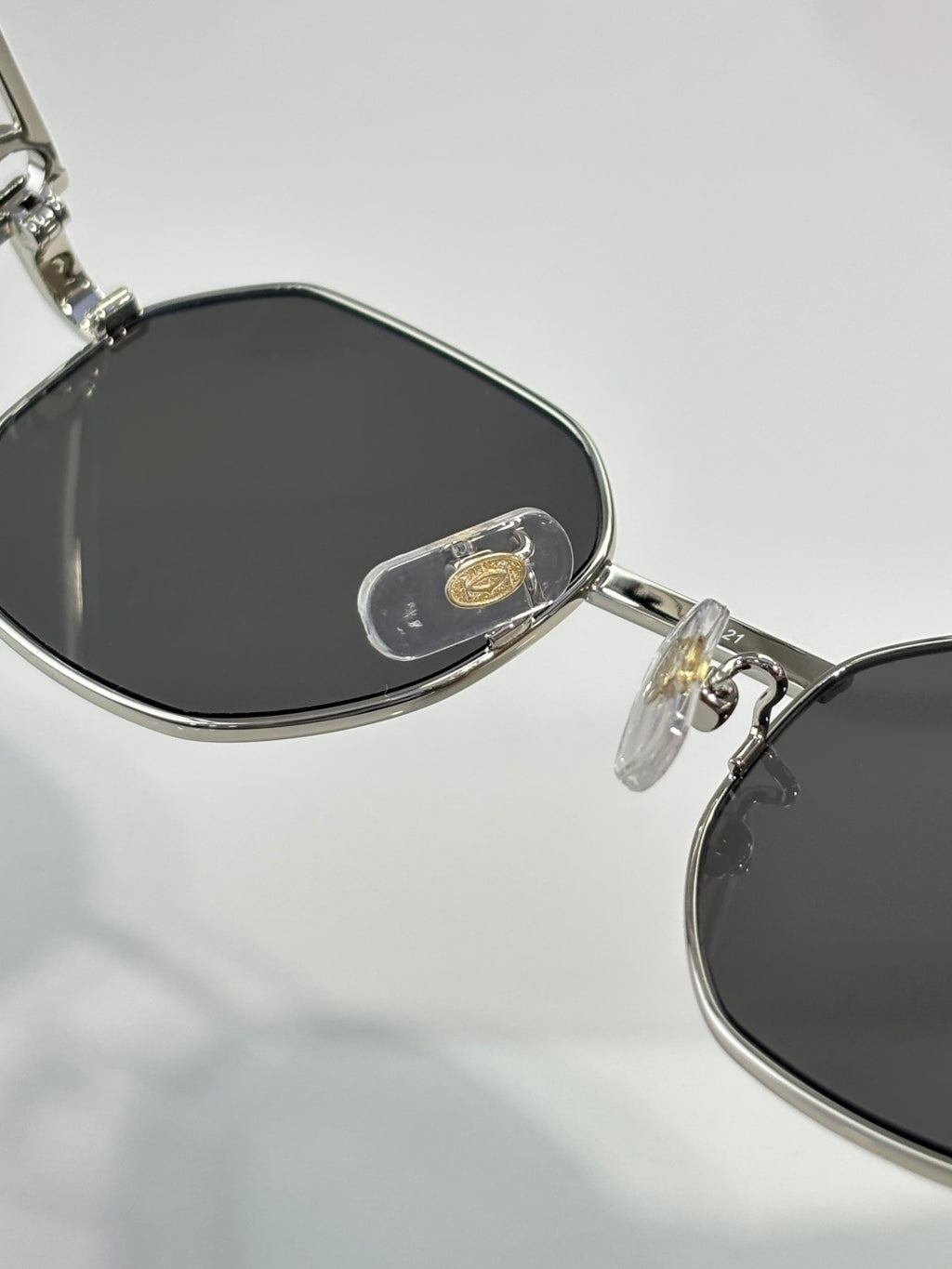 Cartier sunglasses close-up with dark lenses and metal bridge detail