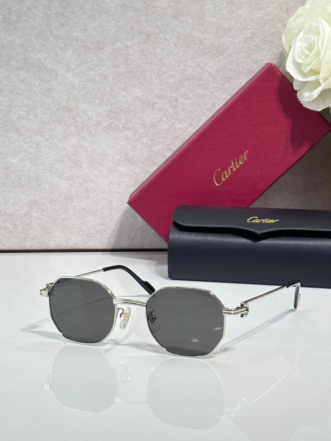 Cartier sunglasses with silver metal frame and dark gray round lenses
