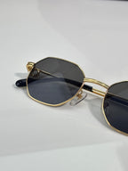 Cartier oval sunglasses with gold-tone frame and dark lenses, angled view