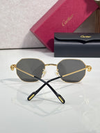 Cartier round sunglasses with gold-tone frame and dark lenses, crossed angle view