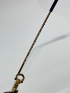 Cartier eyeglasses temple with engraved text and gold-tone metal arm