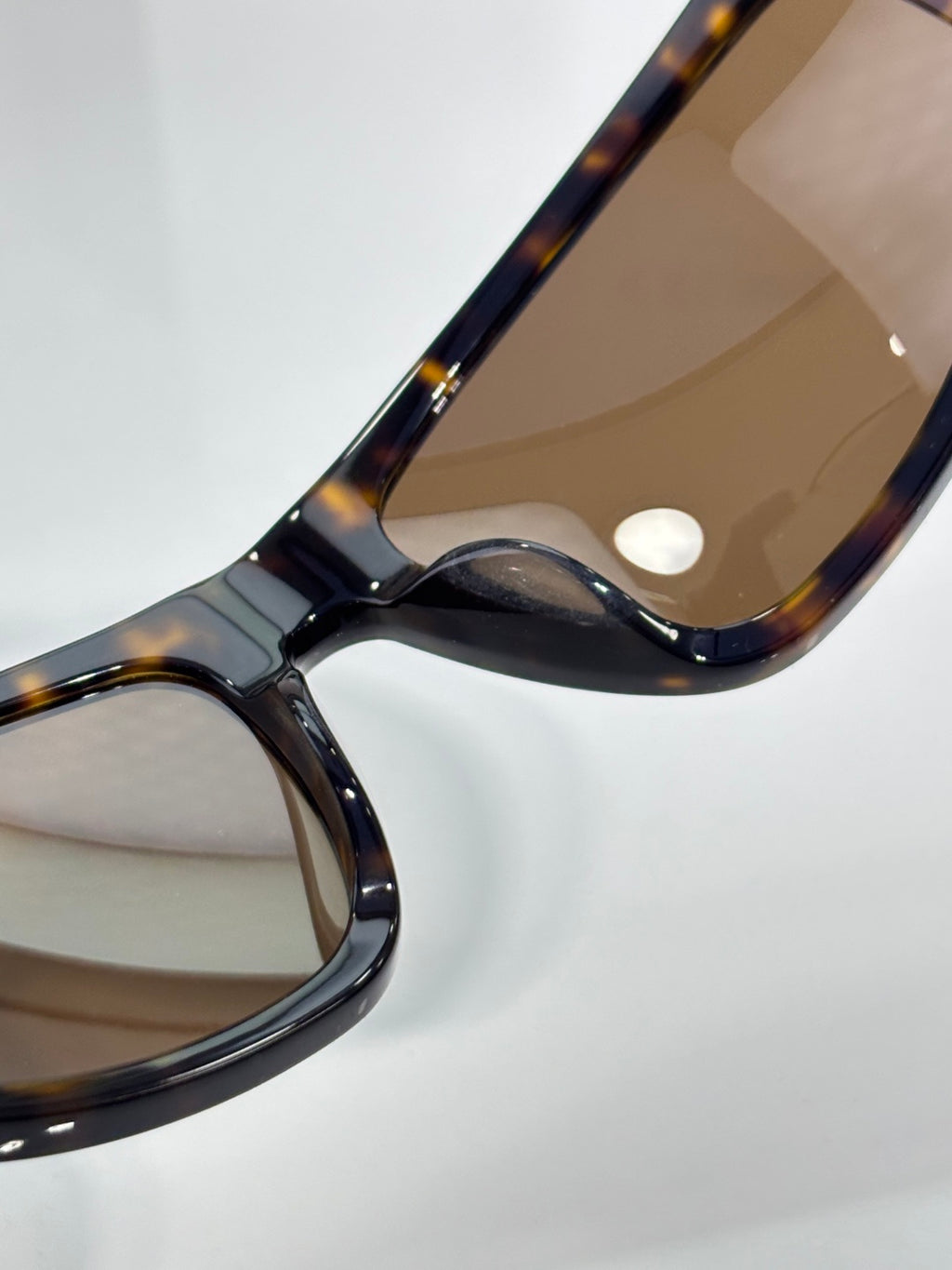 Celine tortoiseshell sunglasses close-up of curved arm and tinted lenses
