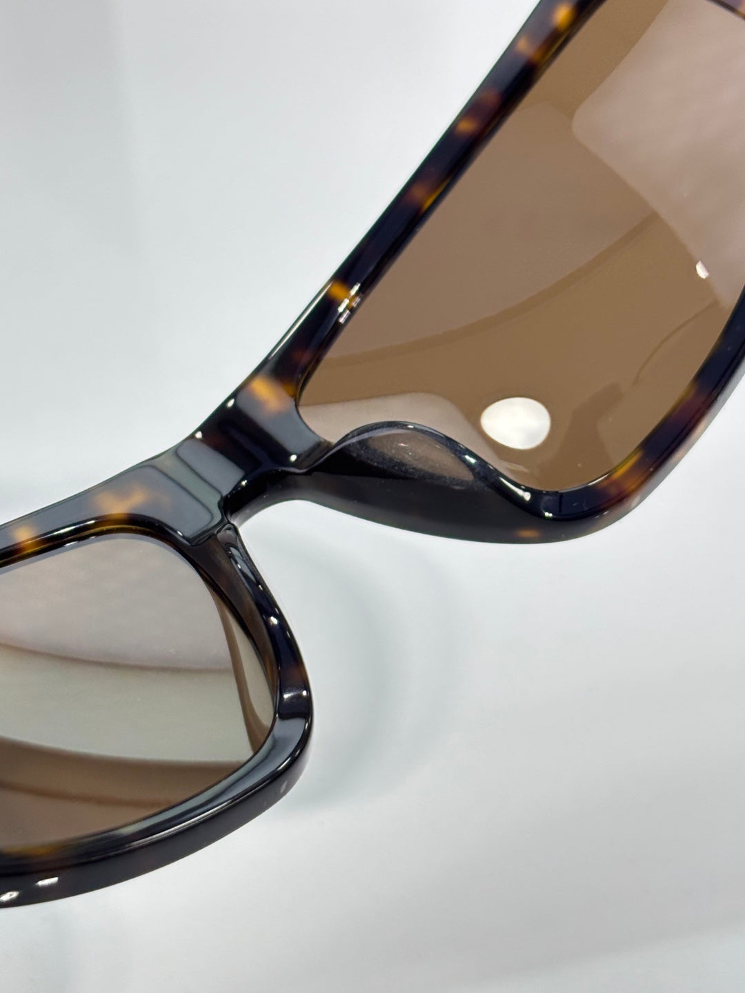 Celine tortoiseshell sunglasses close-up of curved arm and tinted lenses