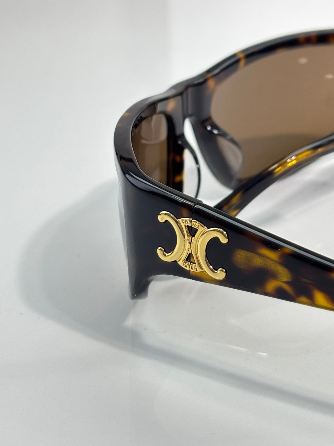 Celine tortoiseshell sunglasses corner with gold logo detail and brown-tinted lens