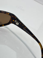 Celine tortoiseshell sunglasses with engraved text on dark temple