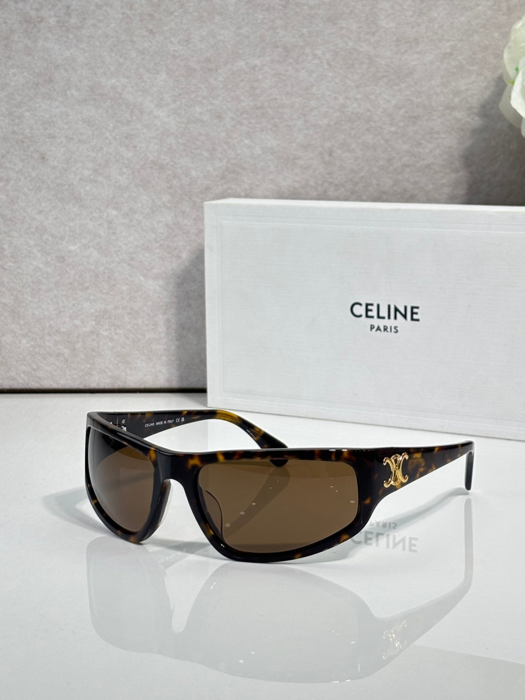 Celine tortoiseshell sunglasses with dark brown lenses and gold logo on temple