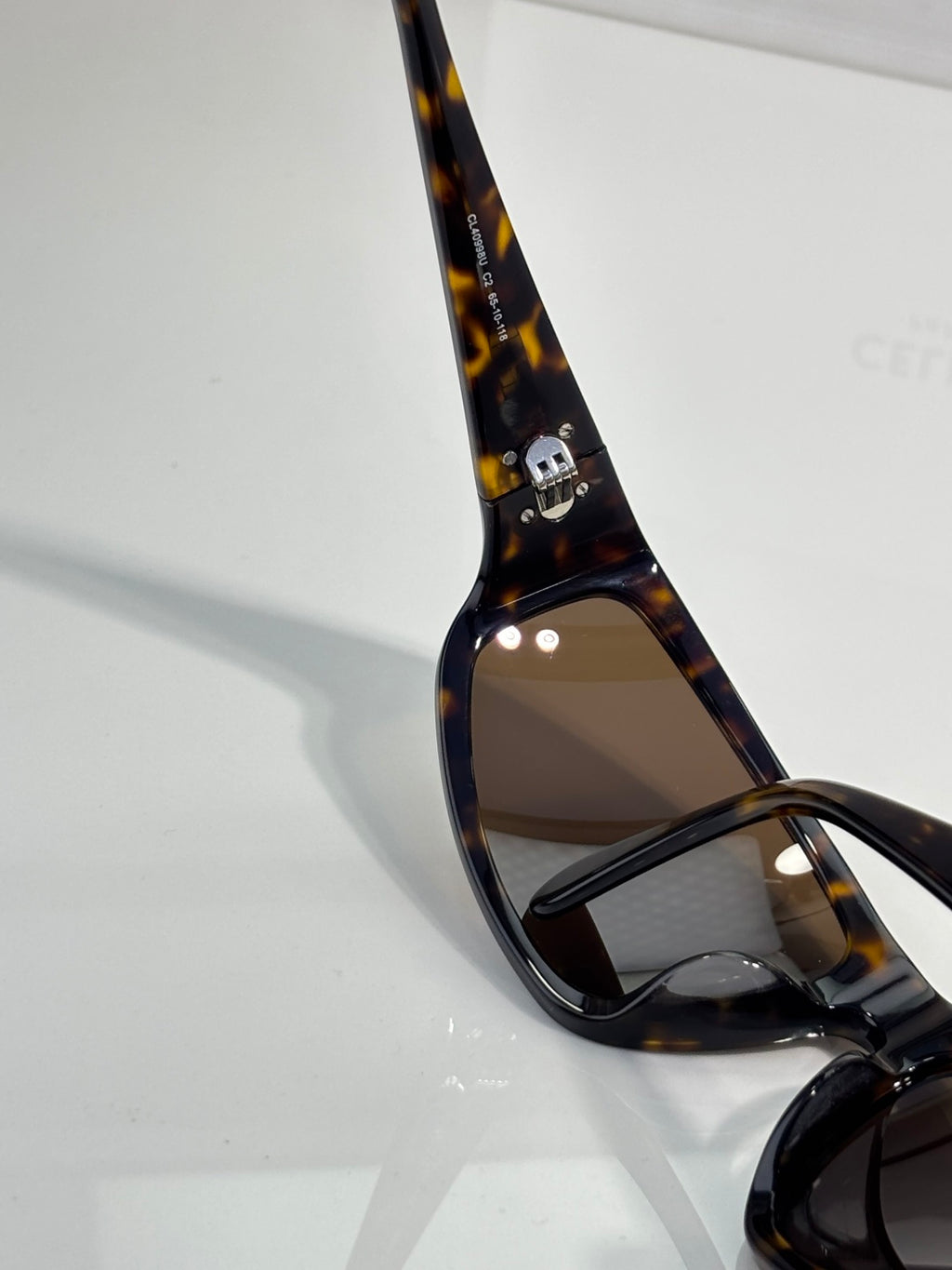 Celine tortoiseshell sunglasses frame with gold detail on temple and tinted lens