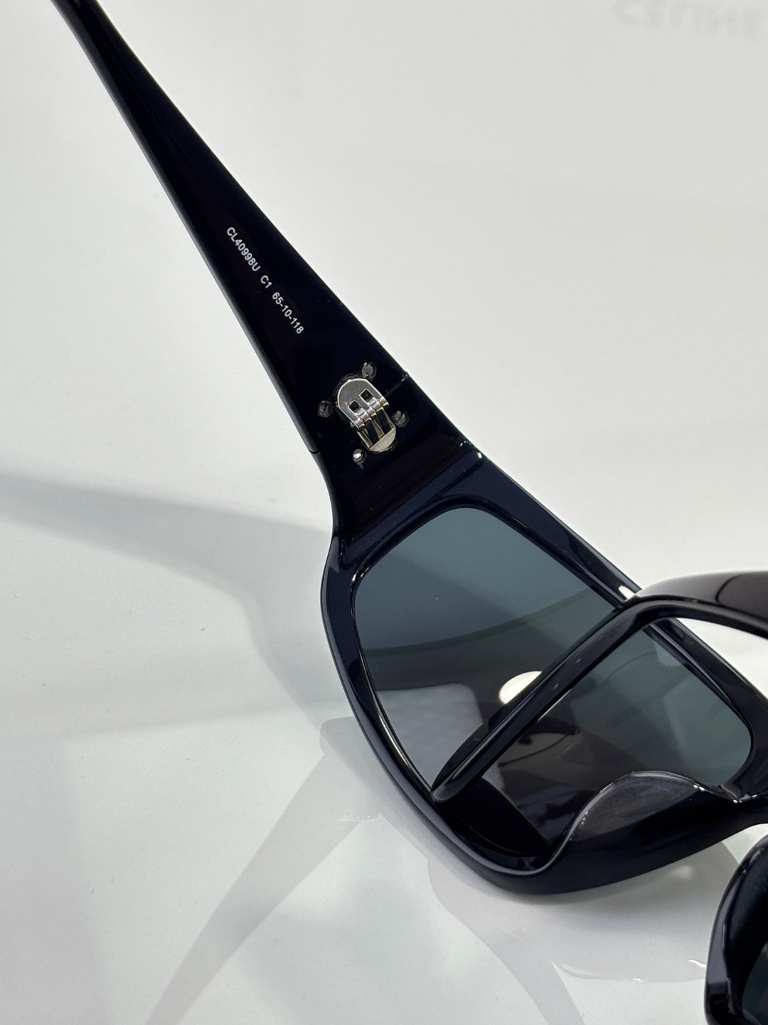 Celine sunglasses temple close-up with dark frame and engraved logo detail