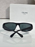 Celine sunglasses with dark frames and tinted dark green lenses, front view