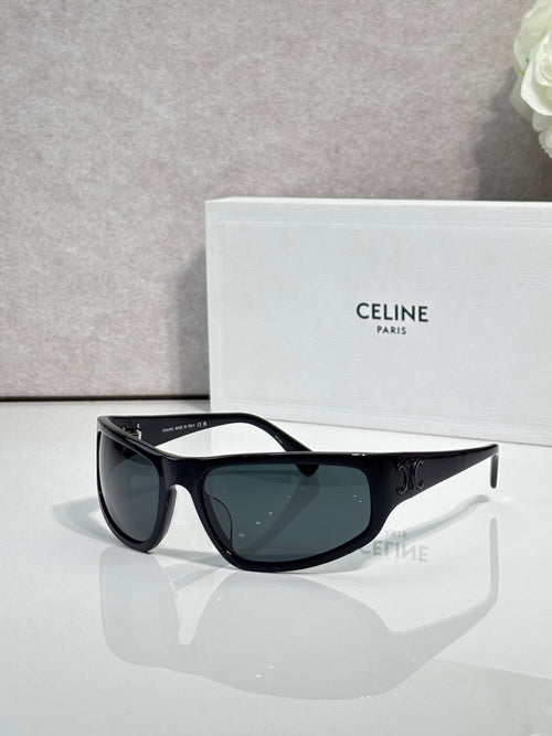 Celine sunglasses with dark frames and tinted dark green lenses, classic cat-eye shape
