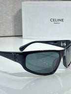 Celine sunglasses with dark frames and tinted dark green lenses, side profile view