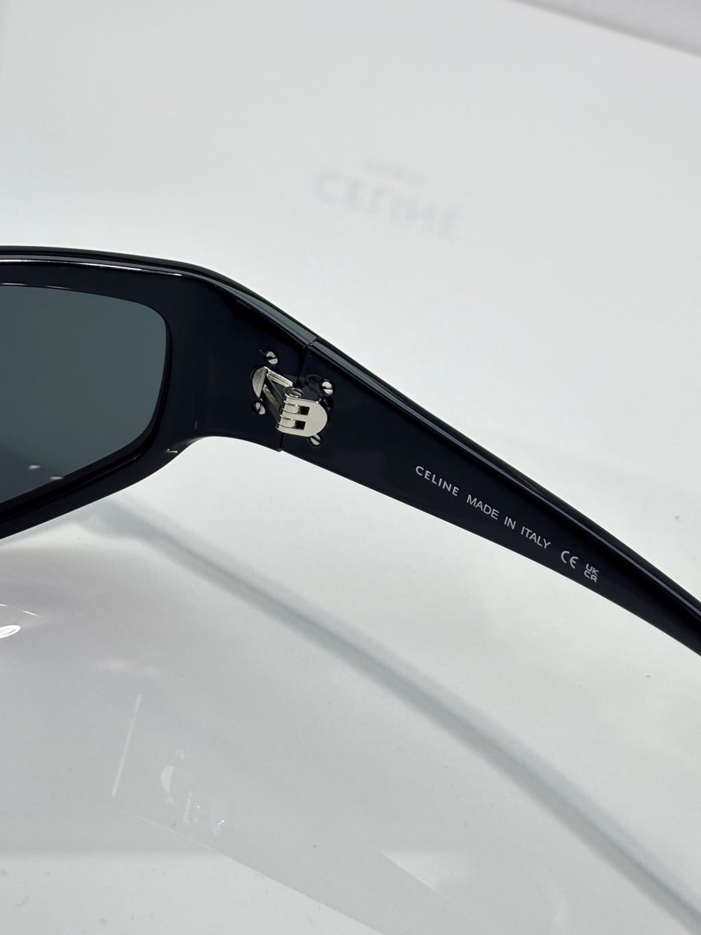 Celine sunglasses temple close-up with brand engraving on dark frame