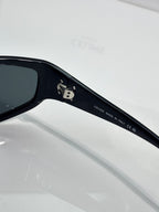 Celine sunglasses temple close-up with brand engraving on dark frame