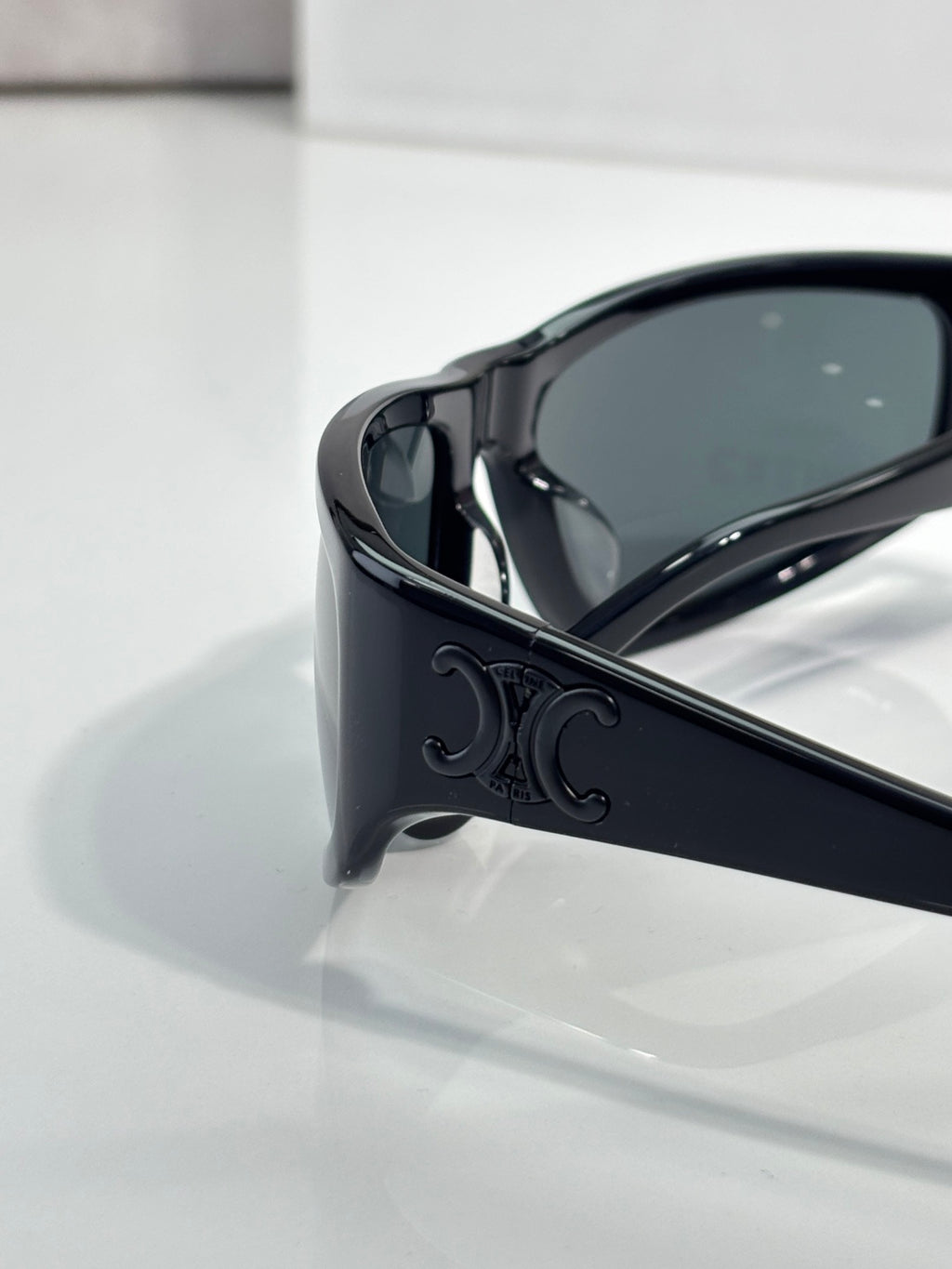 Celine sunglasses corner close-up with dark frame and tinted dark green lens