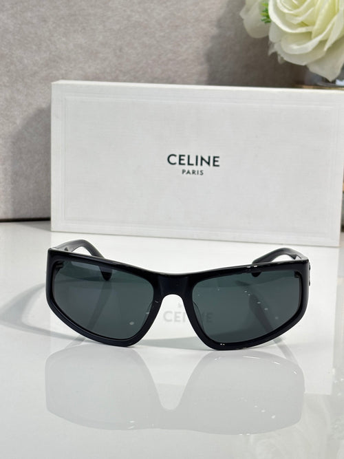 Celine sunglasses with dark frames and tinted lenses, cat-eye silhouette on display