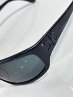Celine sunglasses lens and frame close-up with engraved logo detail on temple