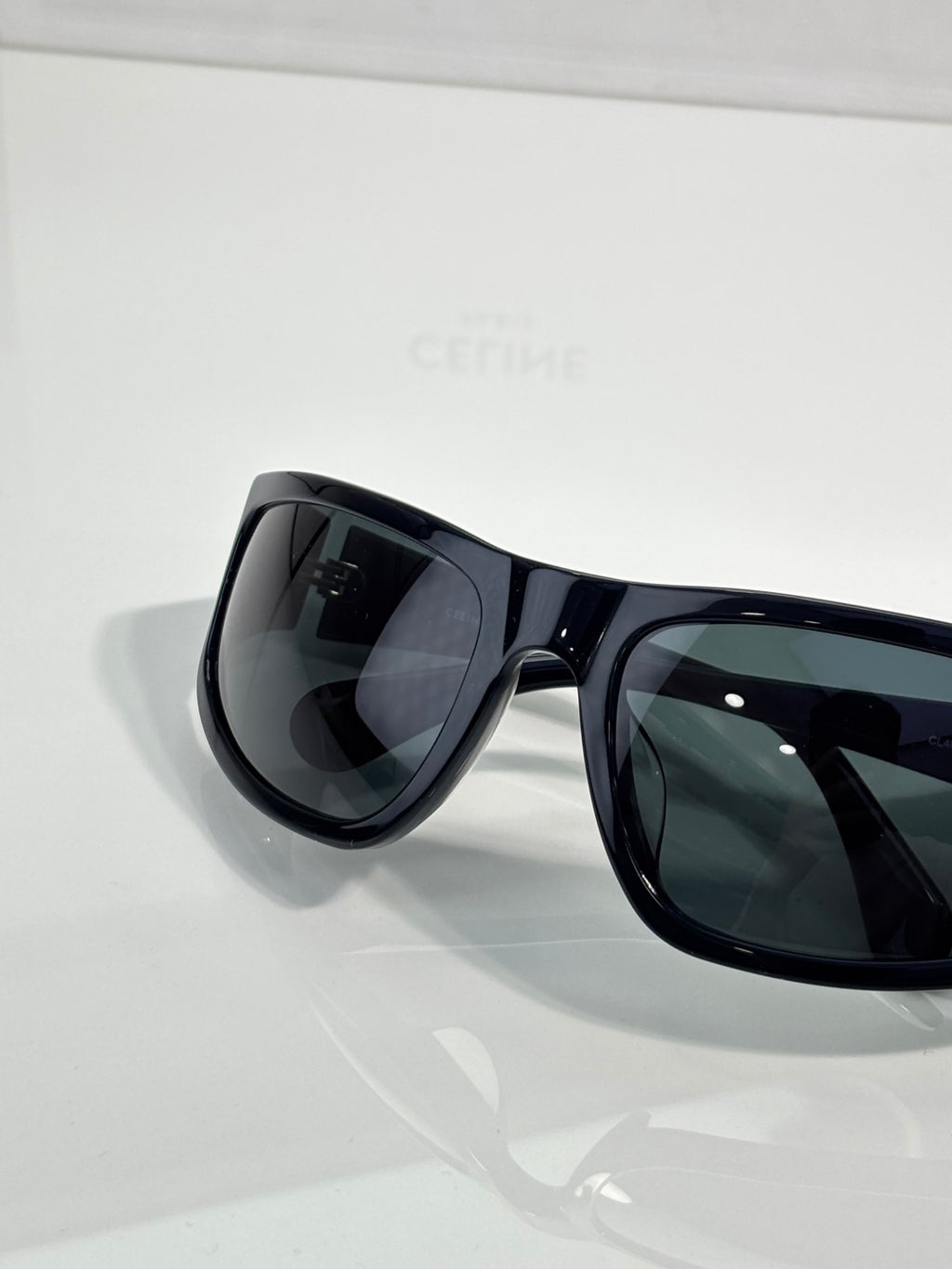 Celine sunglasses with dark frames and tinted lenses, angled front view
