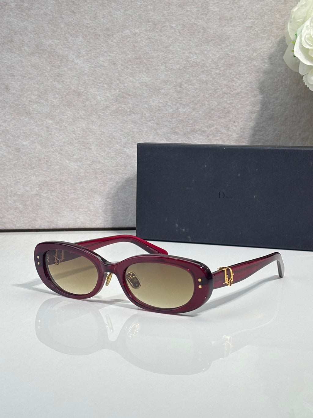 Dior burgundy oval sunglasses with brown lenses and gold-tone hinge