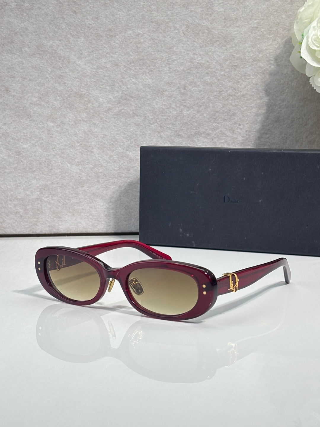 Dior burgundy oval sunglasses with brown lenses and gold-tone hinge