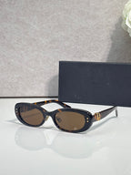Dior tortoiseshell oval sunglasses with brown lenses and gold-tone hinge